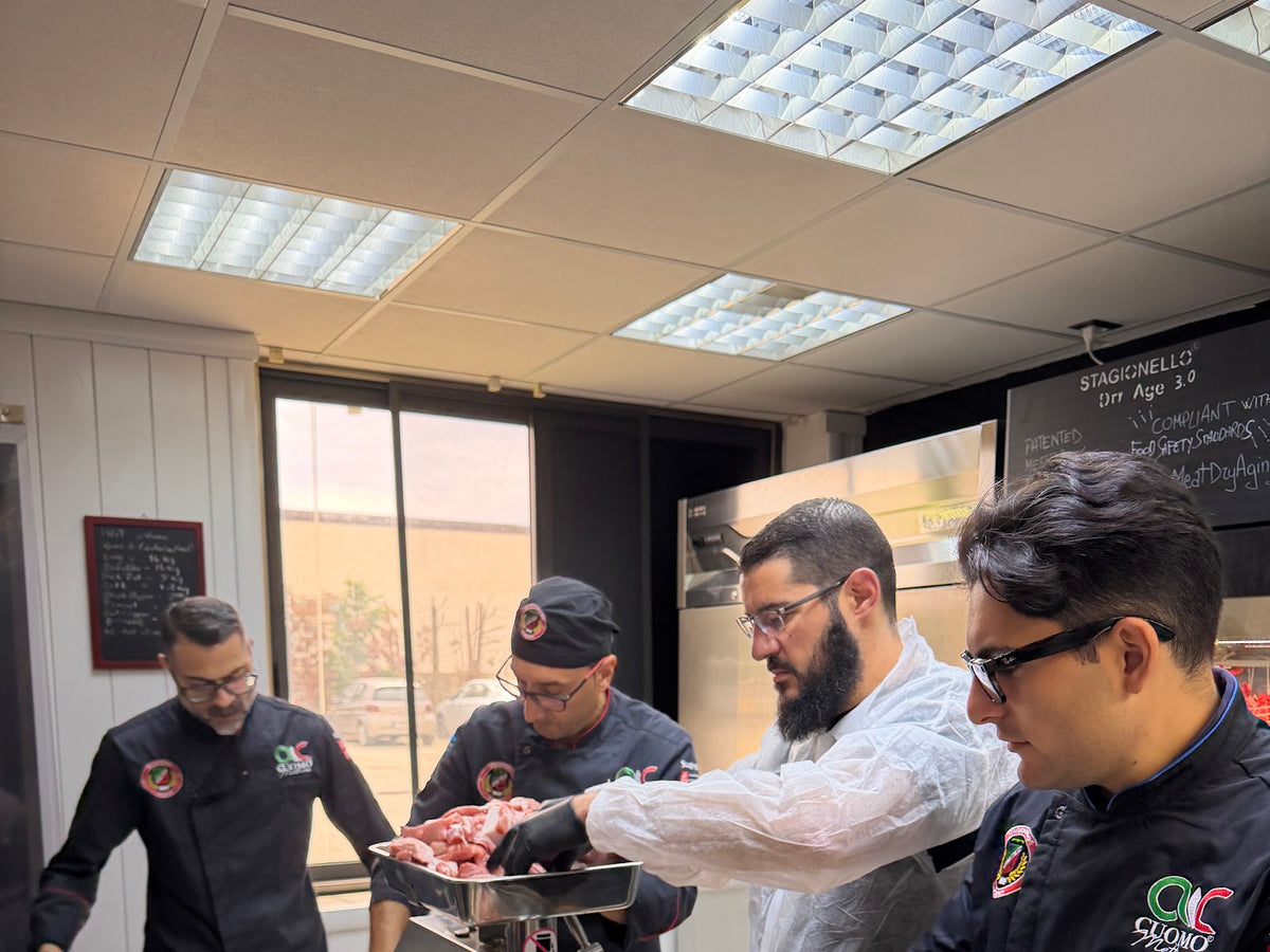 Mike and Kristi Bryan at hands-on Stagionello training in Crotone, Italy, working with the team at a curing bench