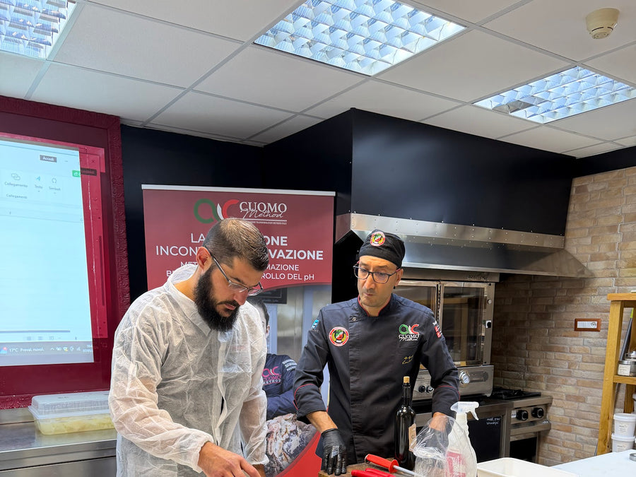 Trainee preparing meat with a Stagionello instructor in the Crotone training kitchen
